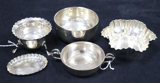 A small silver two-handled bowl, two circular silver bowls, one with waved edge, a fluted silver pin tray and a plated fluted bowl
